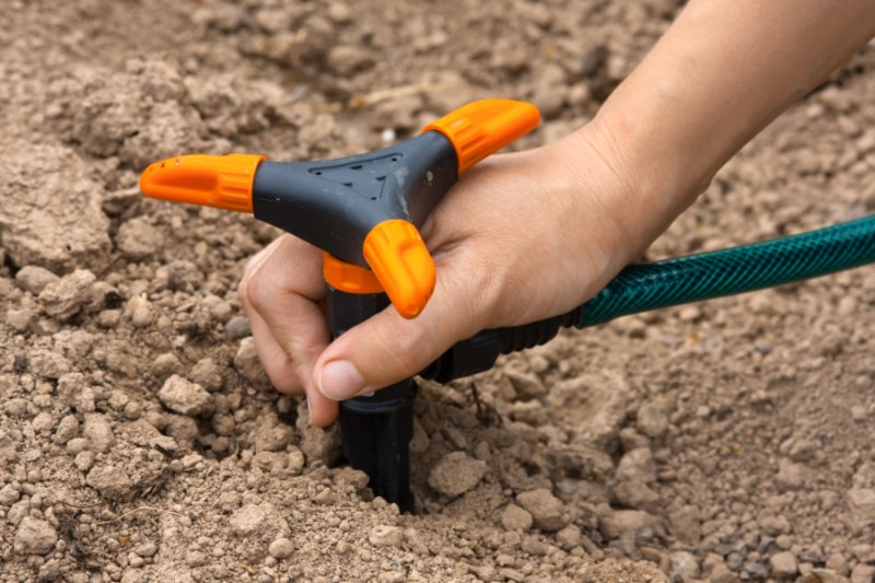 A Man Installing Sprinkler for Irrigation in Bountiful, UT